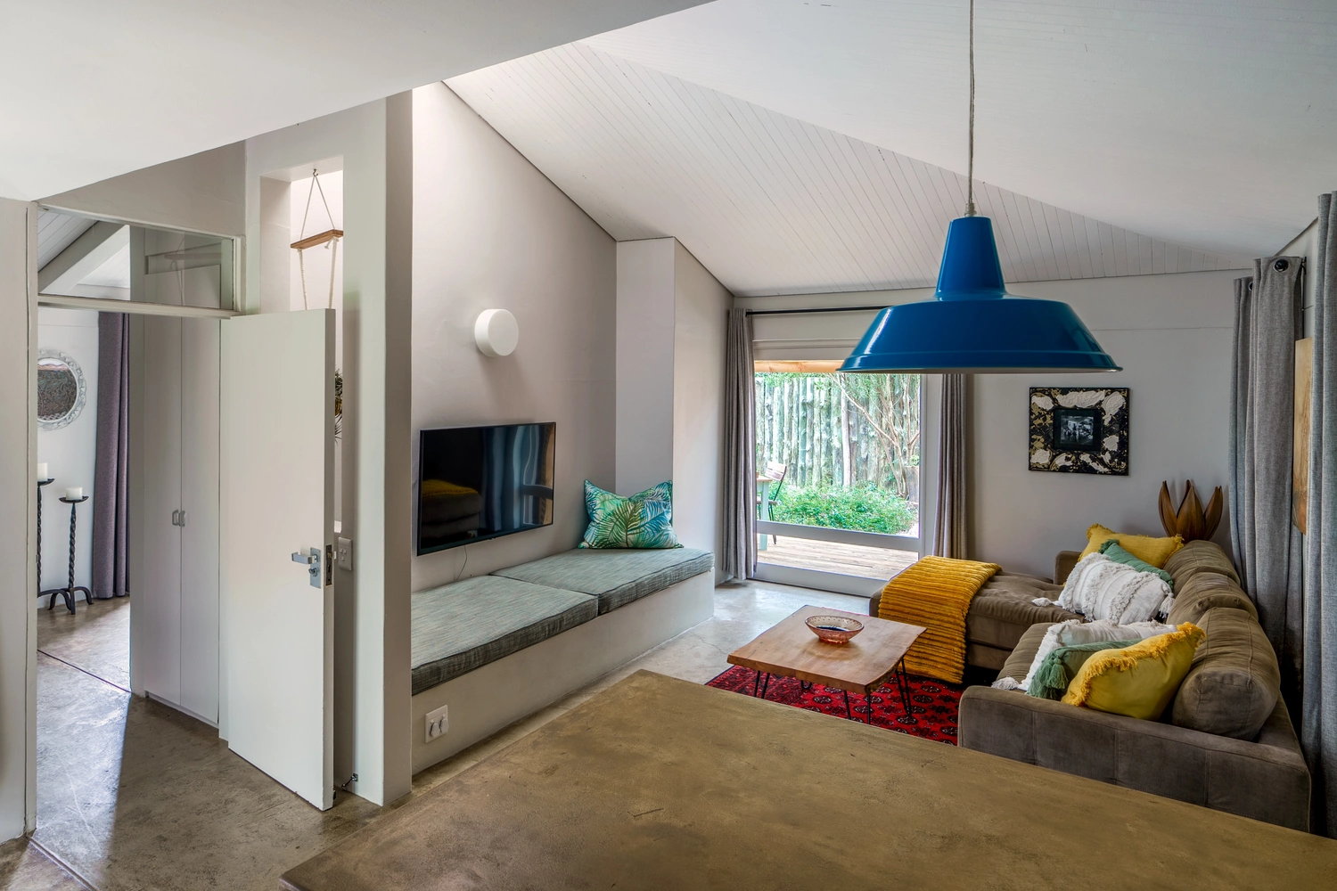 Open plan living area. This is an elevated view from the kitchen which splits into your own private patio/garden and onto the bedroom with it's own en-suite bathroom